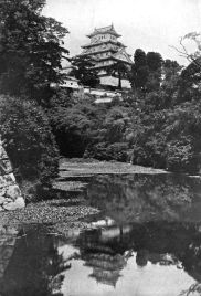 AN OLD FEUDAL CASTLE FROM THE MOAT In lotus-land Japan, 1910 by H.G.Ponting